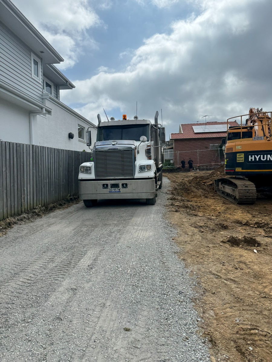 Truck and excavator loading out on a tight-access site, Concord NSW