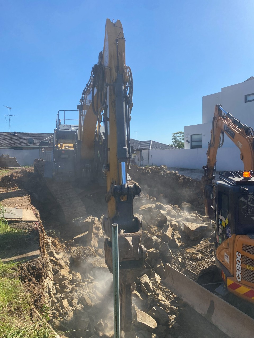 Excavator fitted with a rock-breaker attachment, Sydney NSW